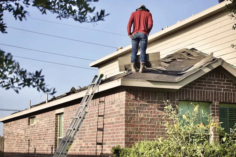 Professional roofer working on a residential roof in Burke Centre